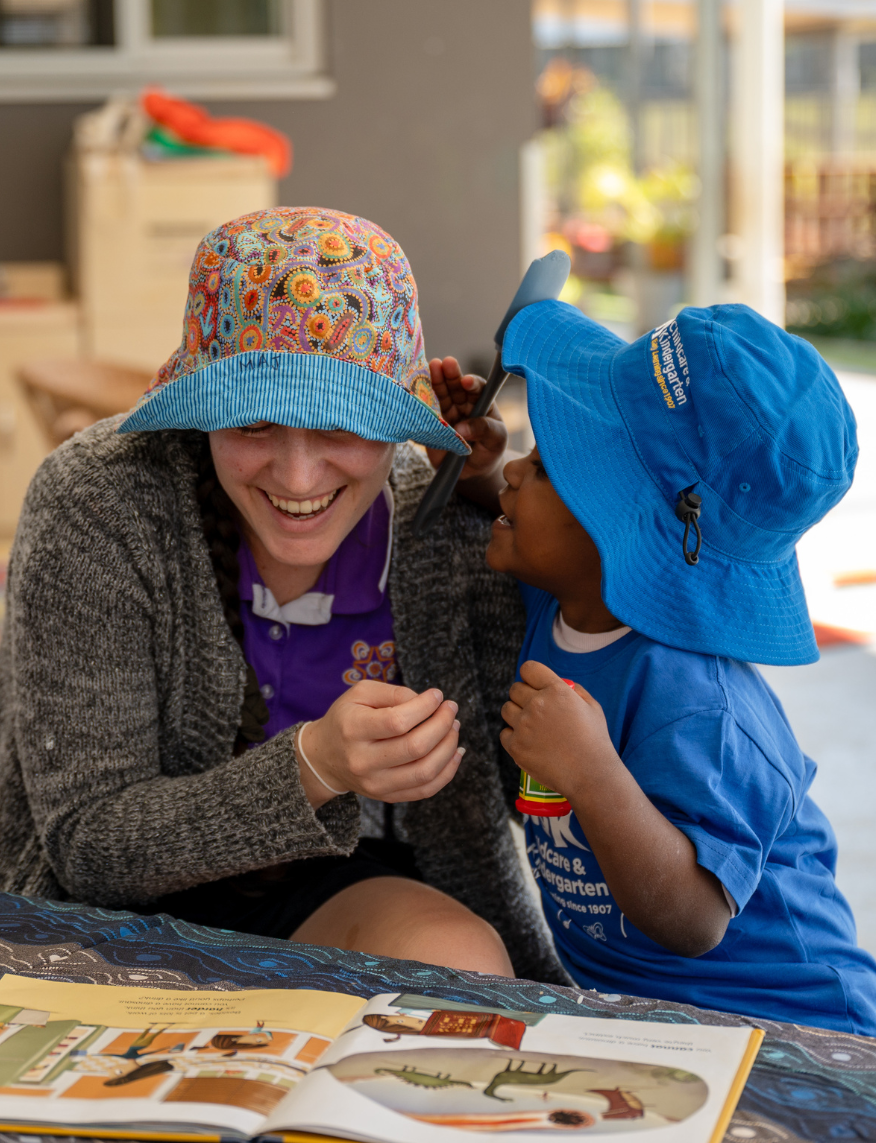 Educator and child laughing