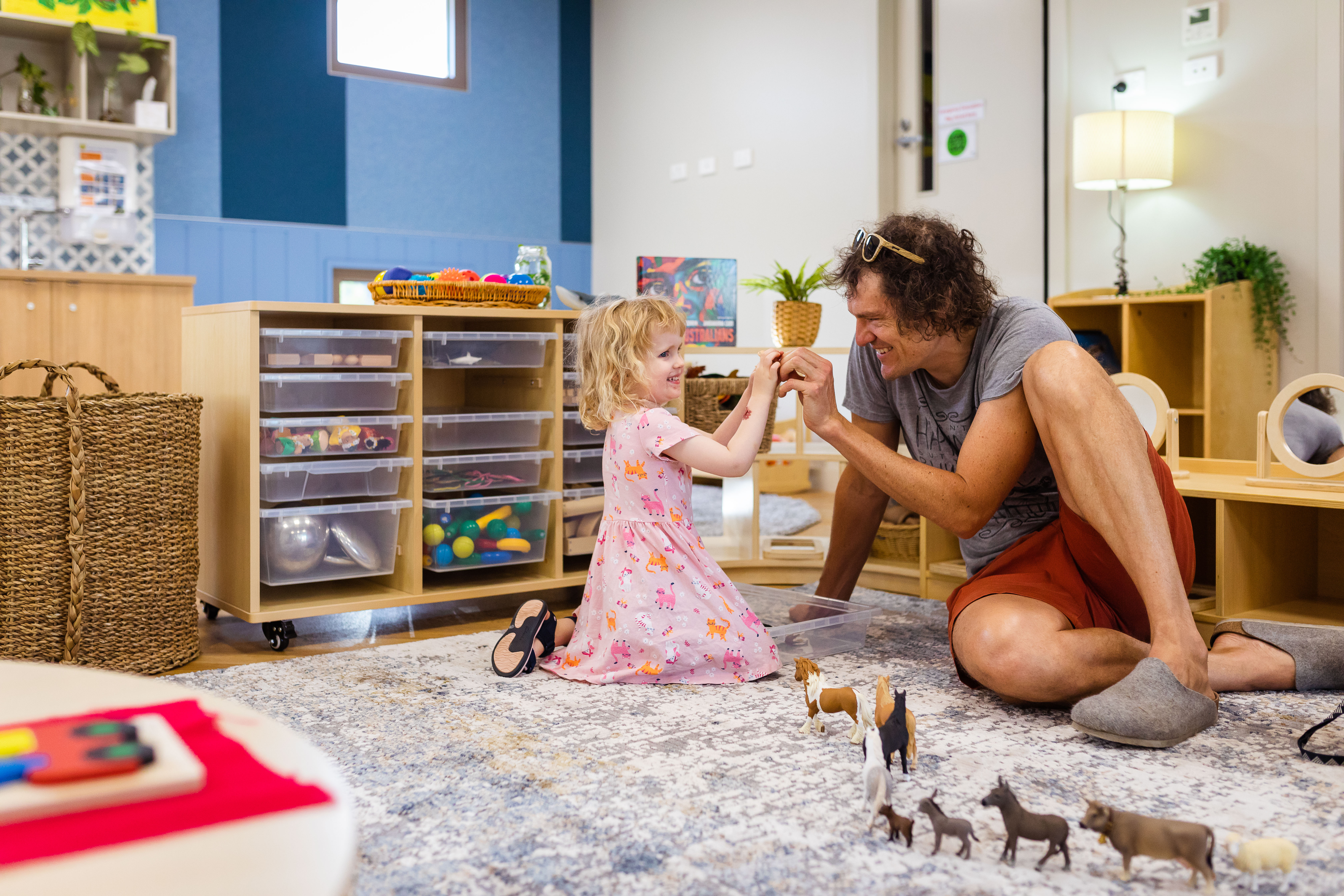 Dad and kindergaten aged daughter high-fiving