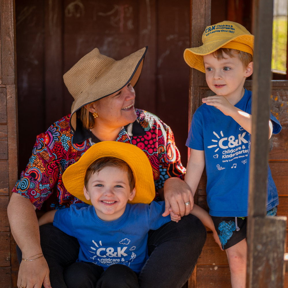 C&K educator and children in playground fort