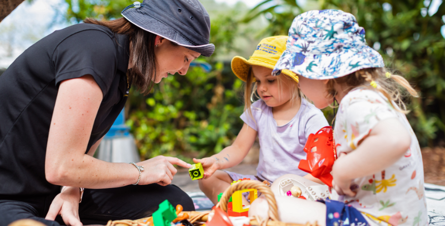 C&K's learning progam teacher with children outside