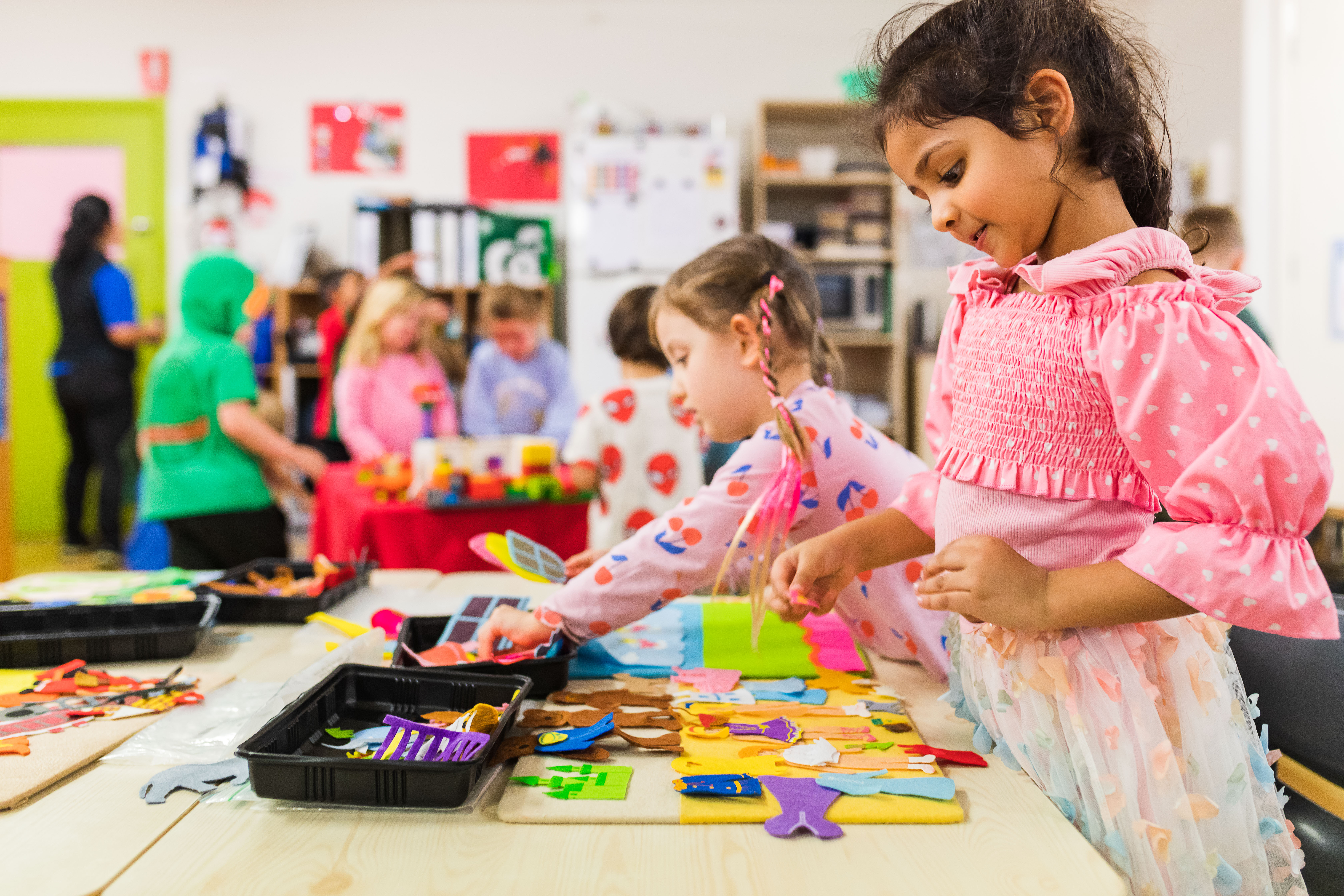 Two children doing craft inside