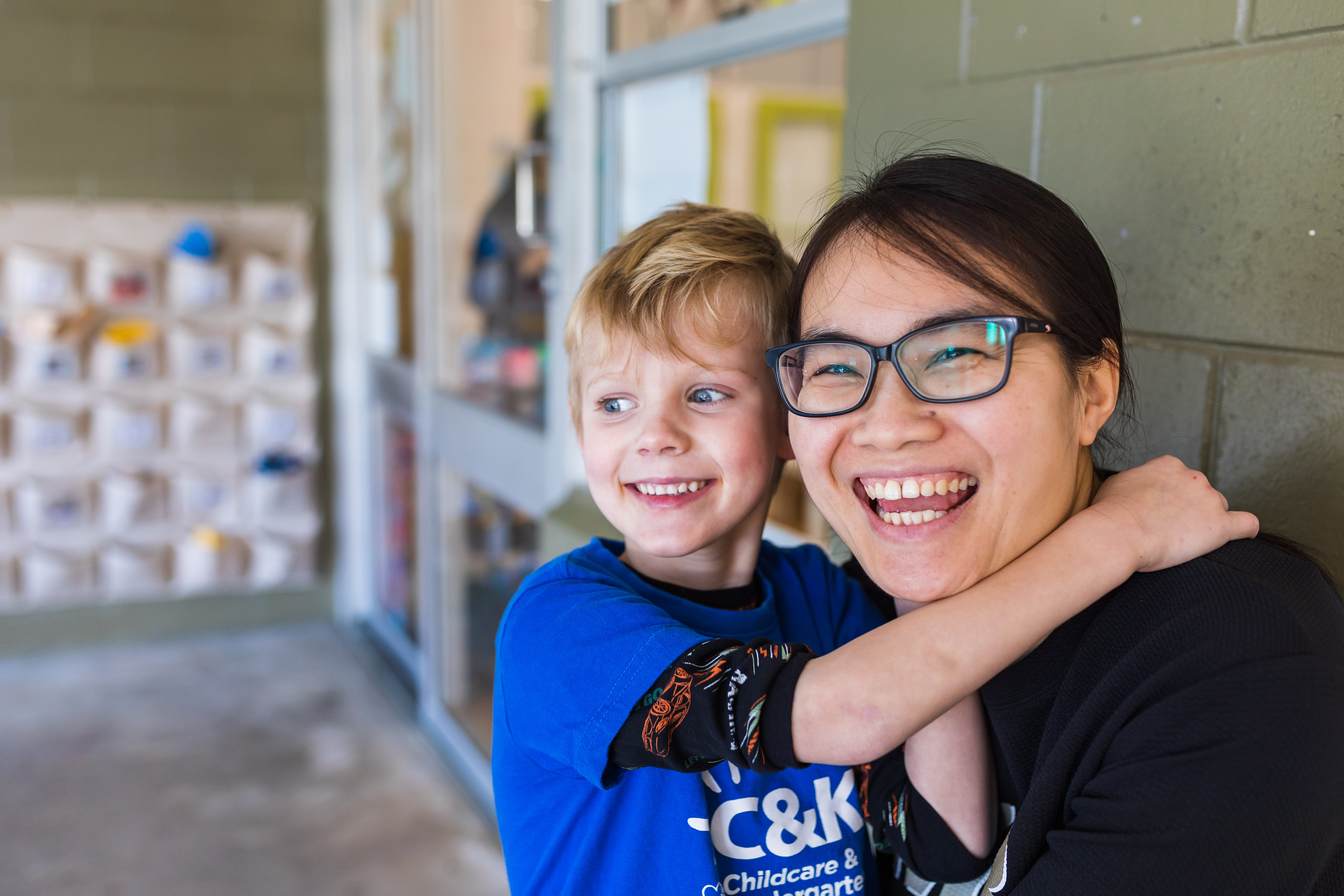 Educator and child together smiling