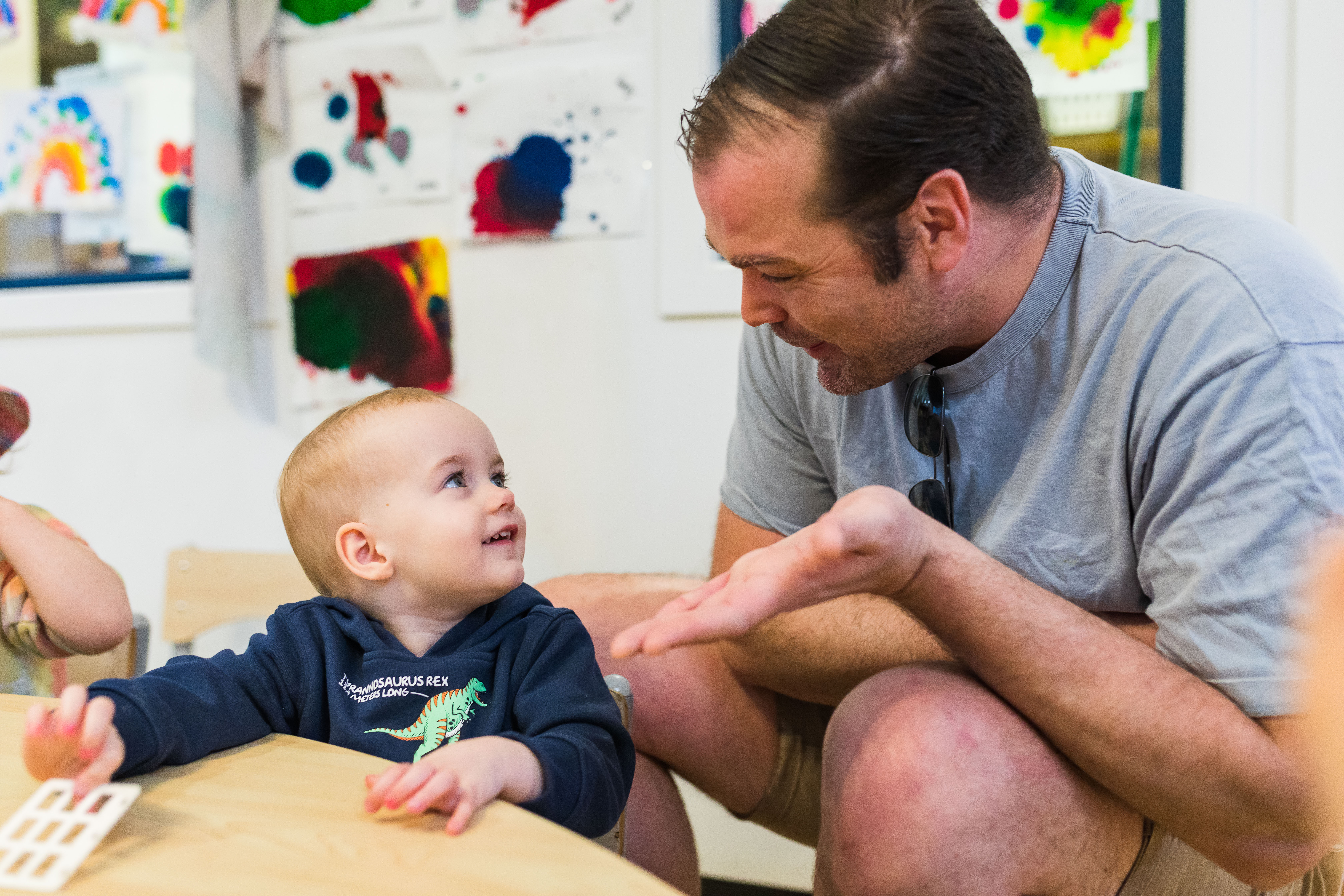 father and baby at low furniture inside